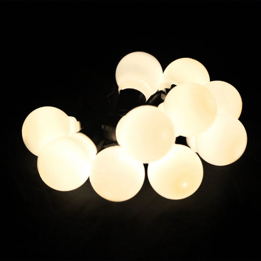 Modern ceiling light fixture with multiple round bulbs on a black background
