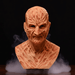 Wooden bust with detailed carvings on a dark background